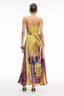 Woman wearing a colorful floral dress on a white background